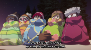 Image of the protagonists, at a campsite, bundled up in blankets, with the caption: "Secret Society BLANKET spreads its influence further".